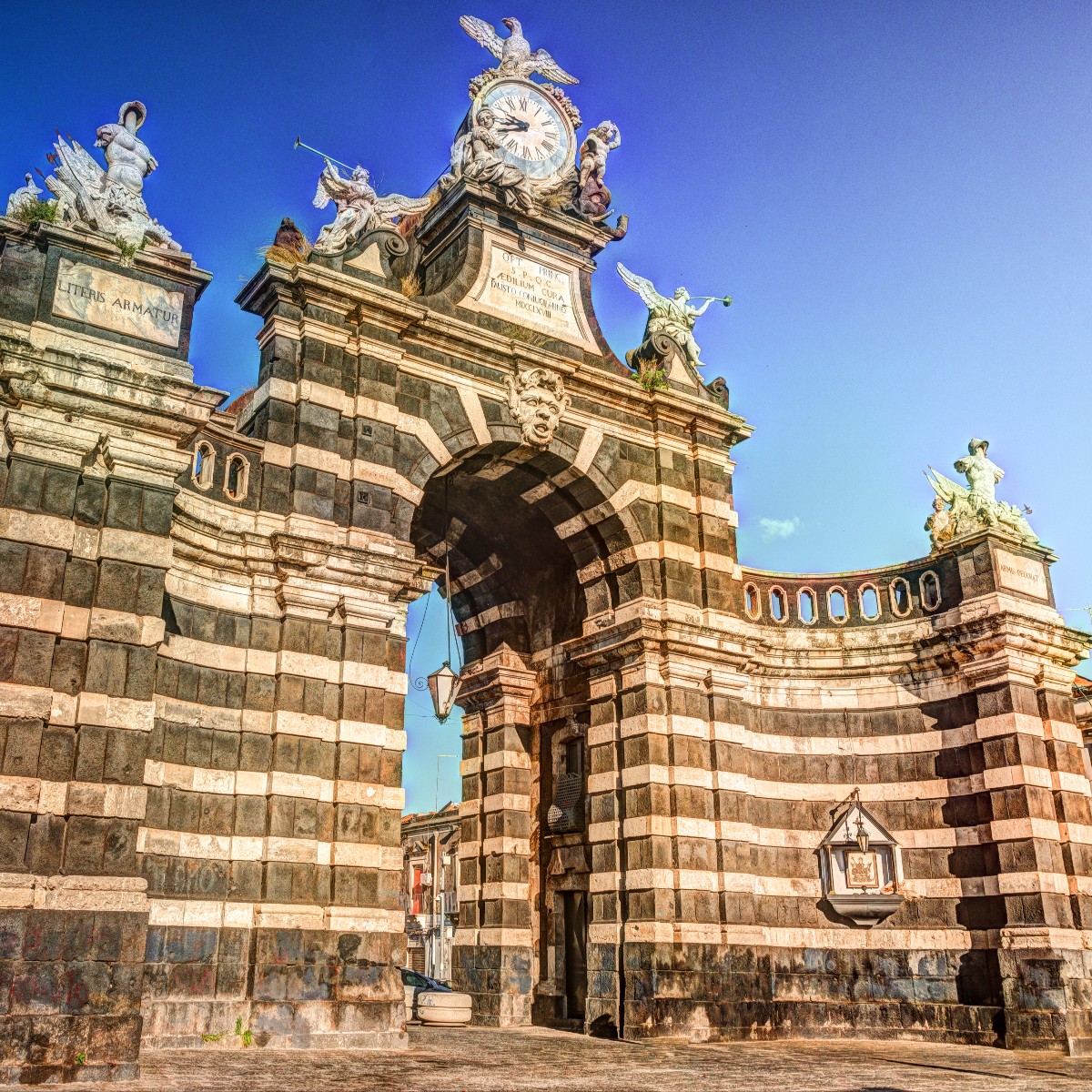 Porta Garibaldi in Catania, a striking Baroque gateway built with black lava stone and white limestone.